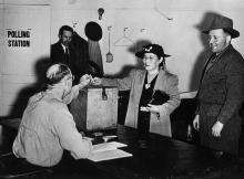 VRTT - Japanese - 1948 UPDATED Photograph of a Japanese woman casting her ballot in a polling station.